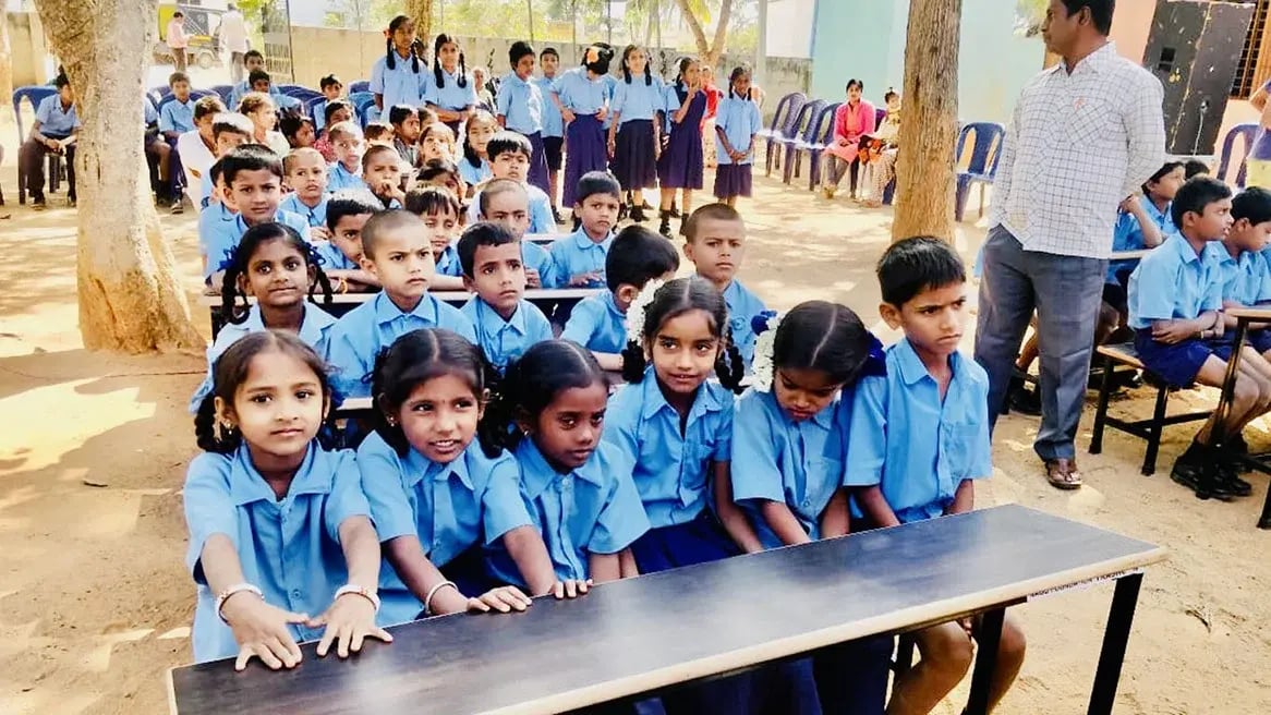 School children in Karnataka at a bench made from recycled waste